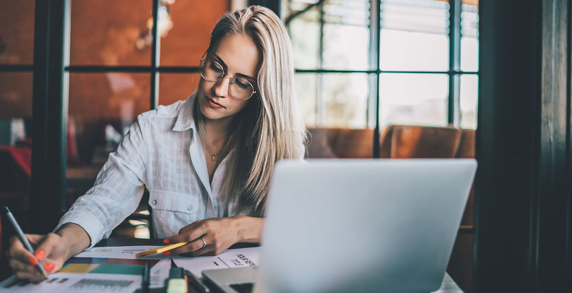 Young focused woman working with chart